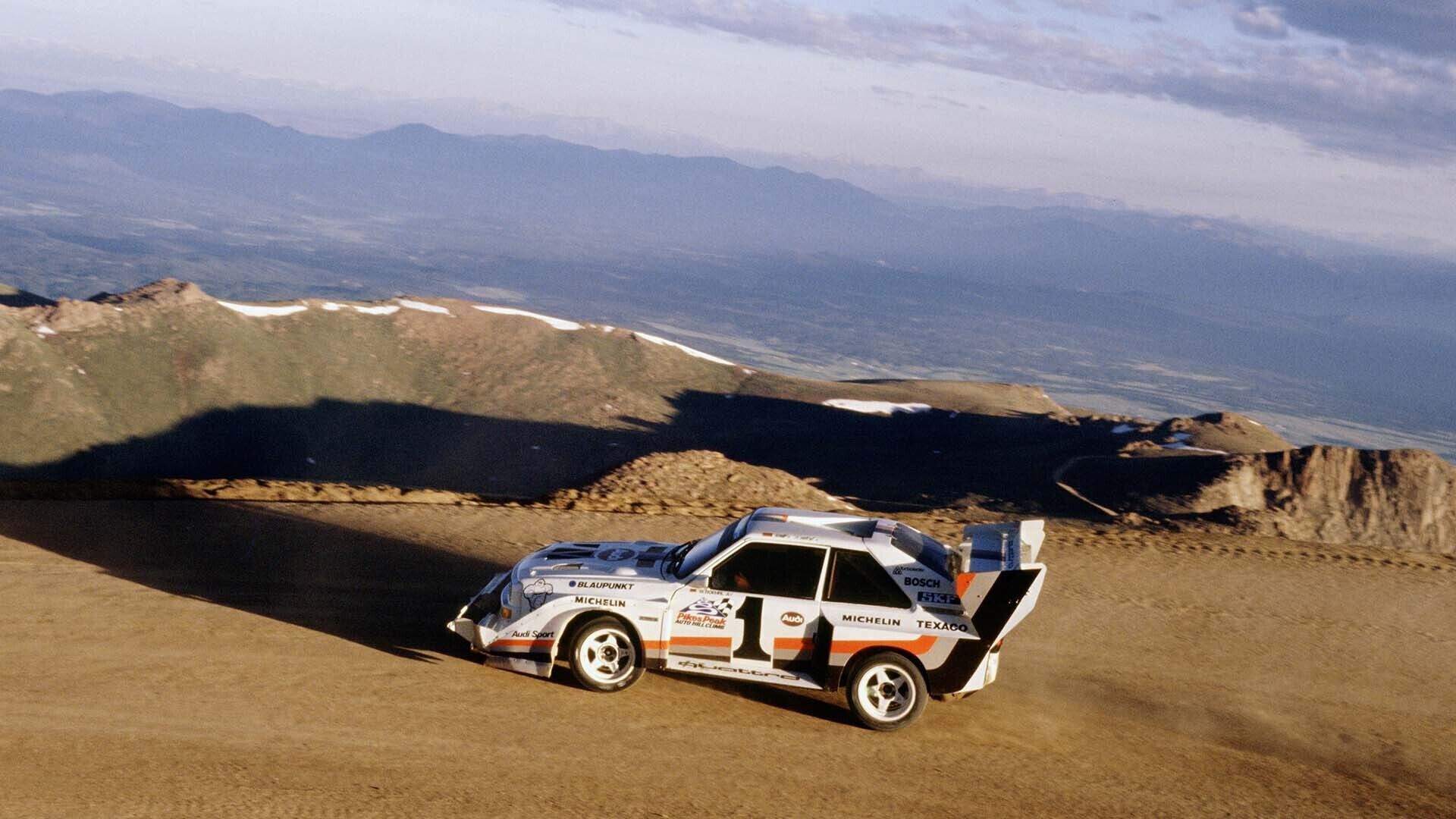 A picture showing an Audi Sport quattro S1 E2 rally car on gravel competing at Pikes Peak in the USA in 1987.