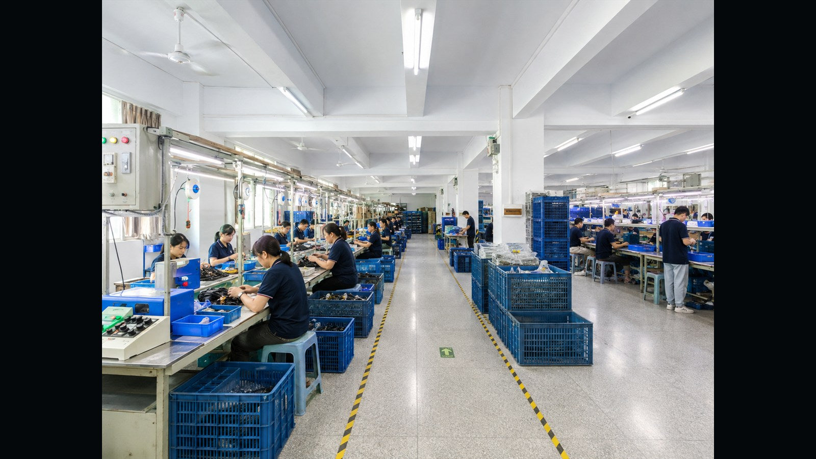 Workers assembling electronic components on a production line