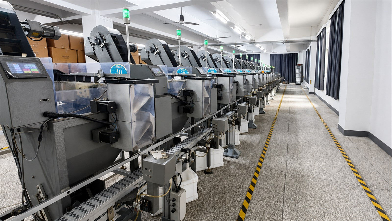 Rows of automated sorting equipment with status indicator lights